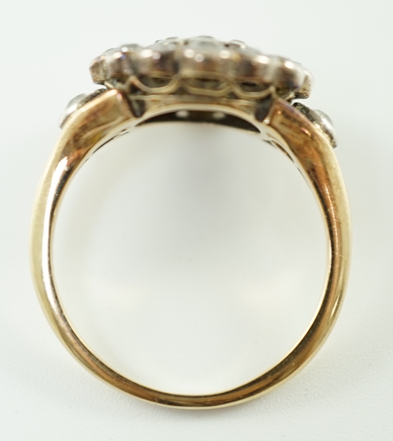 A mid 20th century gold and millegrain set diamond cluster target ring